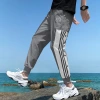 Ice silk pantalón hombre versión coreana nueva tendencia verano holgada paquete de pies nueve puntos deportes casual pantalones de secado rápido para hombres Specification image
